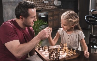 Father daughter play chess